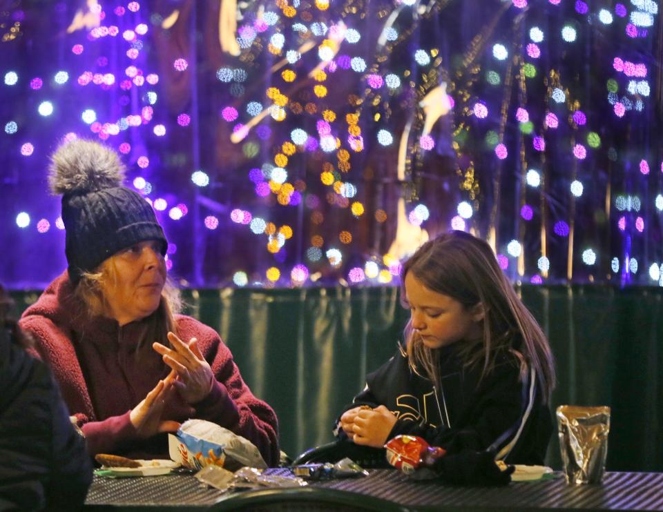 Roxane Cool and her grand daughter Kenzley Cool, 7 enjoy a snack during the Wishes Can Happen family event at the Akron Zoo on Saturday.