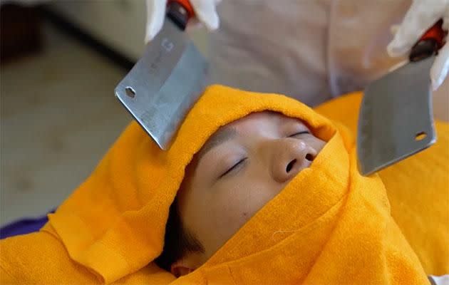 Just a thin towel separates the knife from the face. Photo: Caters