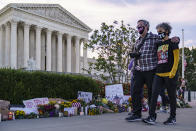 People gather at the Supreme Court on the morning after the death of Justice Ruth Bader Ginsburg, 87, one of the high court's liberal justices, and a champion of gender equality, in Washington, Saturday, Sept. 19, 2020. (AP Photo/J. Scott Applewhite)