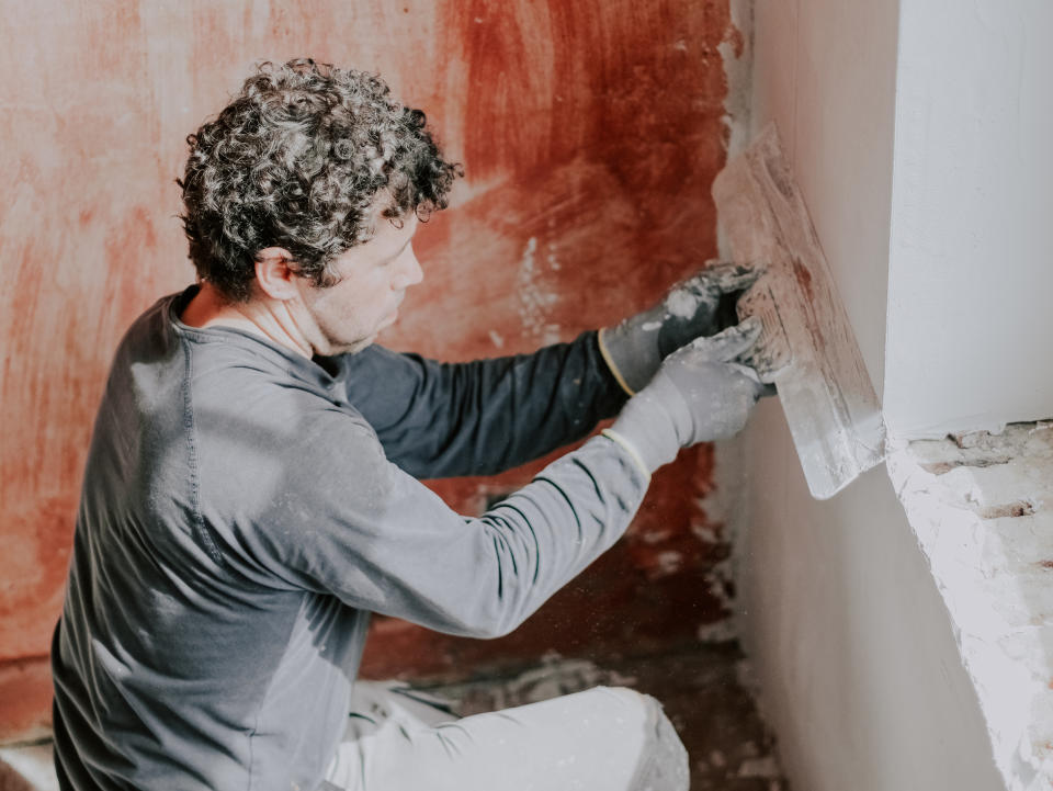 A man fixing a wall