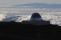 FILE - In this July 14, 2019, file photo, a telescope at the summit of Mauna Kea, Hawaii's tallest mountain is shown. Despite years of legal battles and months of protests by Native Hawaiian opponents, the international coalition that wants to build the world's largest telescope in Hawaii insists that the islands' highest peak, Mauna Kea, is the best place for their $1.4 billion instrument. But just barely. Thirty Meter Telescope officials admit that their backup site atop a peak on the Spanish Canary island of La Palma is a comparable observatory site, and that it wouldn't cost more money or take extra time to build it there. (AP Photo/Caleb Jones, File)