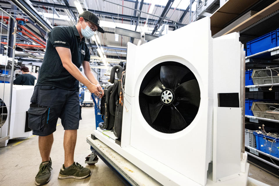 A worker assembles a heat pump at the Stiebel Eltron plant in Holzminden, Germany, August 11, 2022. REUTERS/Benjamin Westhoff