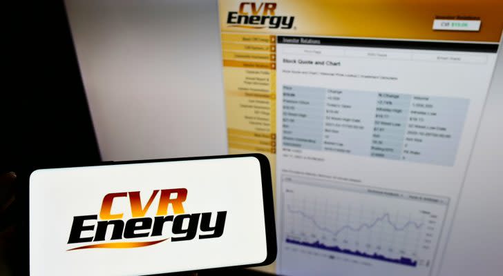 The logo for CVR Energy (CVI) is shown on a cellphone next to a screen displaying the company's website.