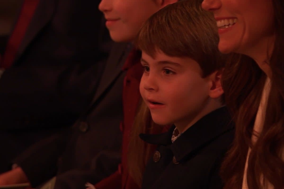 Prince Louis sits beside his mother, Catherine, Princess of Wales at the Royal Carols (ITVX)