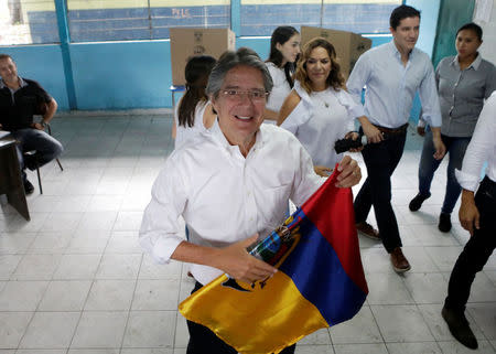 Ecuadorean presidential candidate Guillermo Lasso folds a national flag after casting his vote during the presidential election in Guayaquil, Ecuador April 2, 2017. REUTERS/Henry Romero