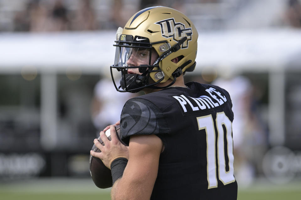 FILE - Central Florida quarterback John Rhys Plumlee (10) warms up before an NCAA college football game against Georgia Tech on Sept. 24, 2022, in Orlando, Fla. Plumlee is the consummate two-sport athlete for Central Florida. (AP Photo/Phelan M. Ebenhack, File)