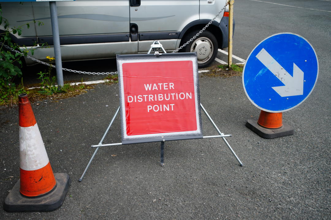 A sign advertising water distribution in Brixham. 