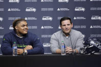 Seattle Seahawks 2024 first round draft pick, Byron Murphy II, left, listens as a head coach Mike Macdonald, right, speaks during a news conference at the NFL team's headquarters, Thursday, May 2, 2024, in Renton, Wash. (AP Photo/John Froschauer)