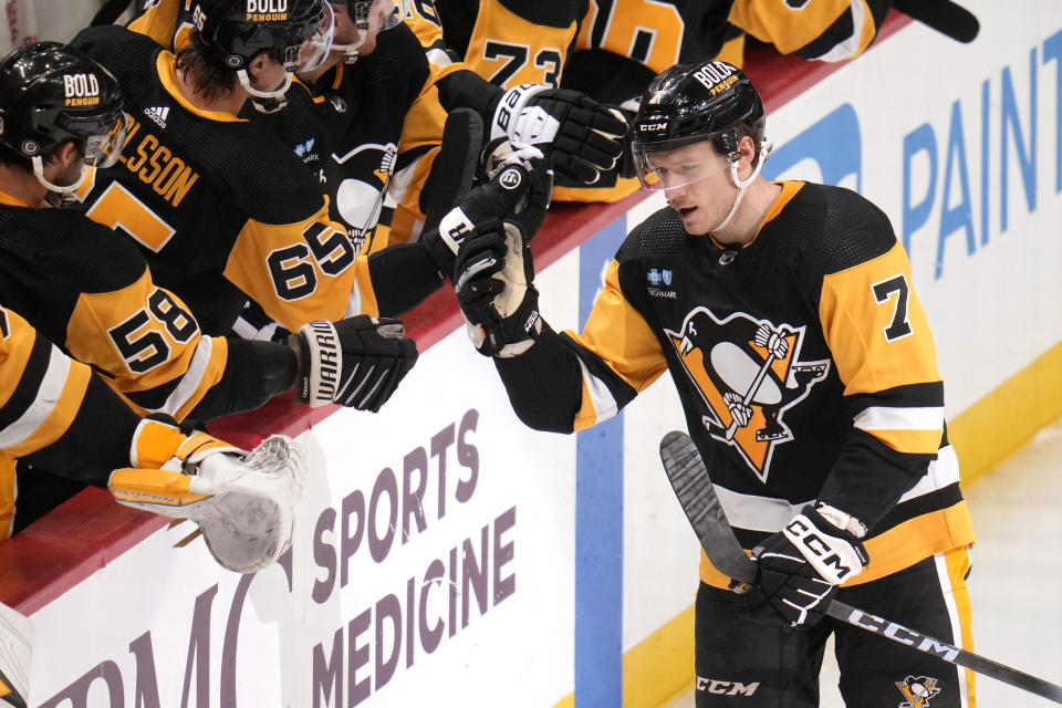 Pittsburgh Penguins' John Ludvig (7) returns to the bench after scoring his first NHL goal during the third period of an NHL hockey game against the Florida Panthers in Pittsburgh, Wednesday, Feb. 14, 2024. The Panthers won 5-2. (AP Photo/Gene J. Puskar)