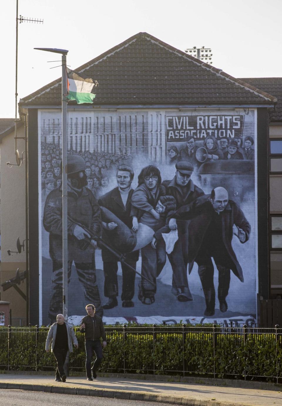 People walk past the Bloody Sunday Commemoration mural in Derry, Northern Ireland (Liam McBurney/PA) (PA Wire)