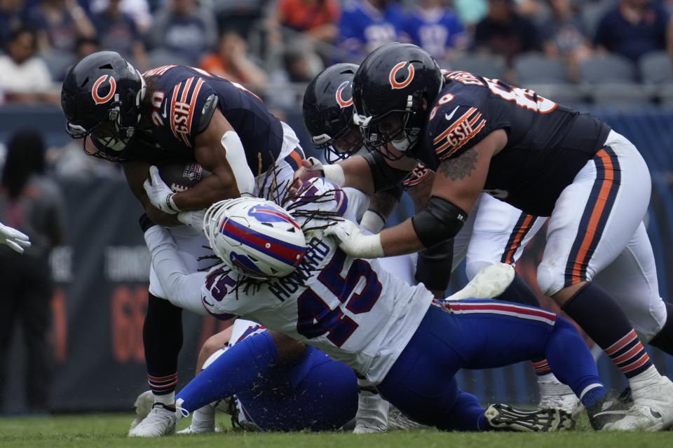 Chicago Bears' Travis Homer (20) is tackled by Buffalo Bills' Travin Howard (45) during the second half of an NFL preseason football game, Saturday, Aug. 26, 2023, in Chicago. (AP Photo/Nam Y. Huh)