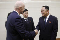 FIFA President Gianni Infantino, left, shakes hands with North Korean Football Association Secretary General Kim Jang San at the Pyongyang Airport in Pyongyang, North Korea Tuesday, Oct. 15, 2019. Infantino arrived in Pyongyang on the day that North Korean and South Korean teams are set to play a World Cup qualifier match in the North’s capital. (AP Photo/Jon Chol Jin)