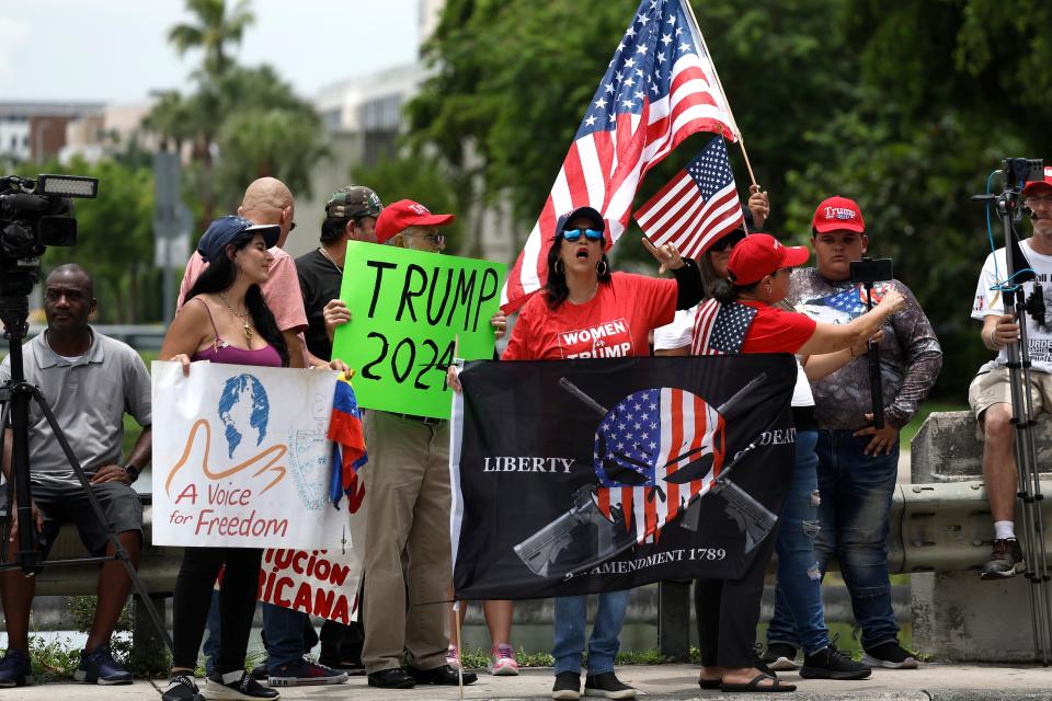 Supporters of former President Donald Trump protest outside of Trump National Doral resort as they await his arrival on Monday in Doral, Fla. Trump is scheduled to appear in federal court for his arraignment on charges including possession of national security documents after leaving office, obstruction, and making false statements.