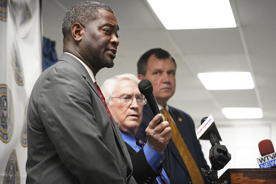 Mississippi Commissioner of Corrections Burl Cain, center, holds the microphone as Jeworski Mallett, Deputy Commissioner of Institution, left, answers a question about the final words spoken by inmate Thomas Edwin Loden Jr., prior to his execution, Wednesday, Dec. 14, 2022, at the Mississippi State Penitentiary in Parchman, Miss. Loden was executed for the rape and murder of a 16-year-old girl. (AP Photo/Rogelio V. Solis)