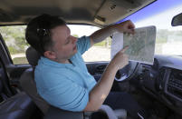 Heath Frantzen uses a map to point out the site of a proposed new natural gas pipeline that would run through his property in the Texas Hill Country, where more than 600 white-tailed and trophy axis deer graze on a 260-acre ranch his family has owned for three generations, near Fredericksburg, Texas Friday, Aug. 2, 2019. (AP Photo/Eric Gay)