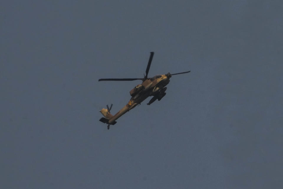 An Israeli Air Force Apache helicopter flies towards the border with Gaza Strip, Friday, Aug. 5, 2022. Palestinian officials say Israeli airstrikes on Gaza have killed several people, including a senior militant, and wounded 40 others. (AP Photo/Ariel Schalit)