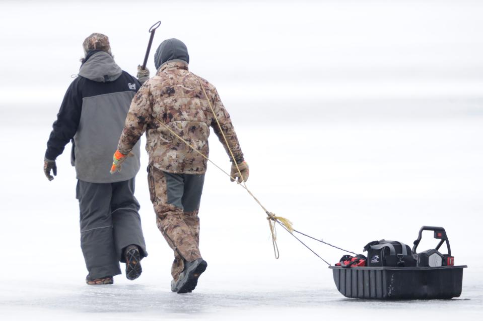 Men head out on the ice at Cowling Bay at the start of the 2024 sturgeon spearing season on Lake Winnebago Saturday, February 10, 2024, in the Town of Vinland, Wis.