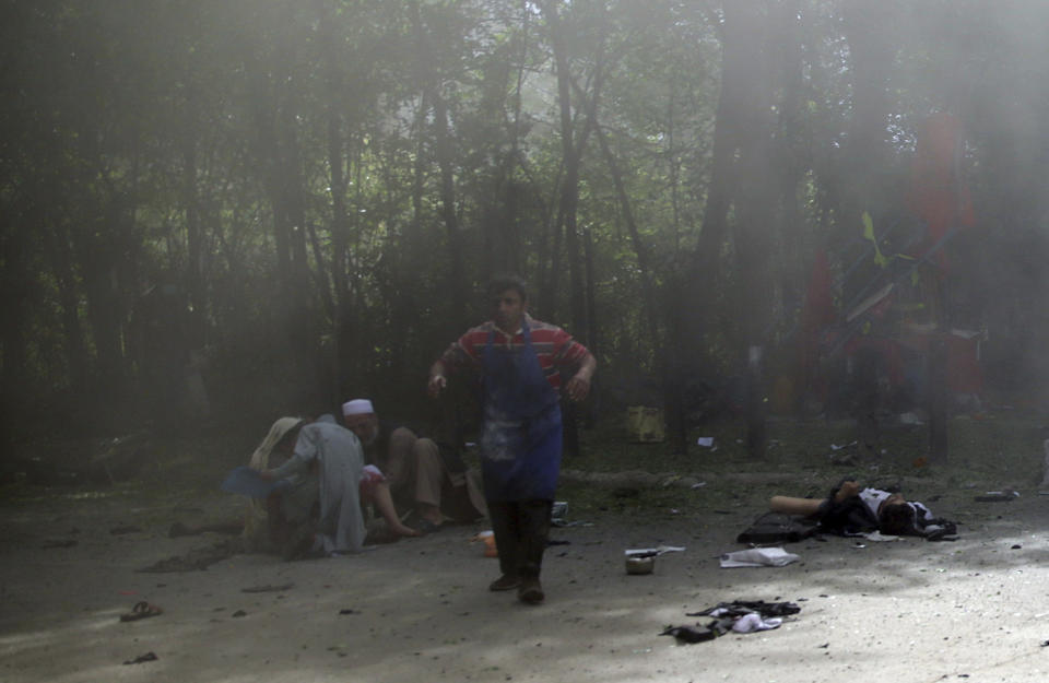 <p>Victims in double explosions, lie on the ground in Kabul, Afghanistan, April 30, 2018. (Photo: Massoud Hossaini/AP) </p>