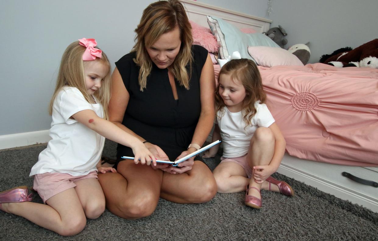 Summer Sheehan reads with her four-year-olds Ivy and Oakley Thursday afternoon, April 18, 2024, at their home in Shelby.