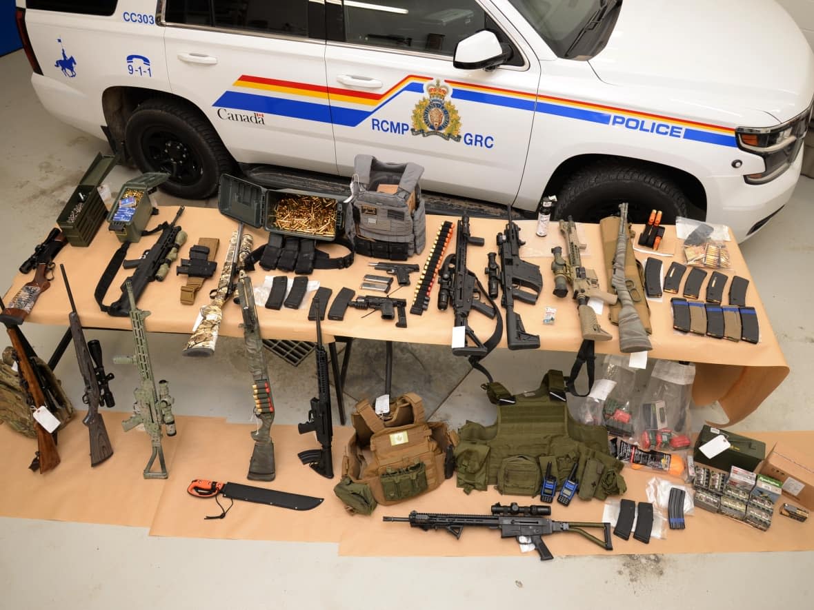 Alberta RCMP submitted this photo of what they say is a cache of firearms and ammunition found in three trailers near a blockade of the Canada-U.S. border. (Submitted by Alberta RCMP - image credit)