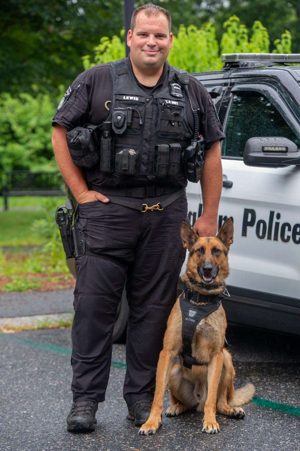 Framingham police officer Andrew Lewis poses with K-9 Murph at Cushing Memorial Park last August. Murph was struck by a gun suspect several times on Sunday evening.
