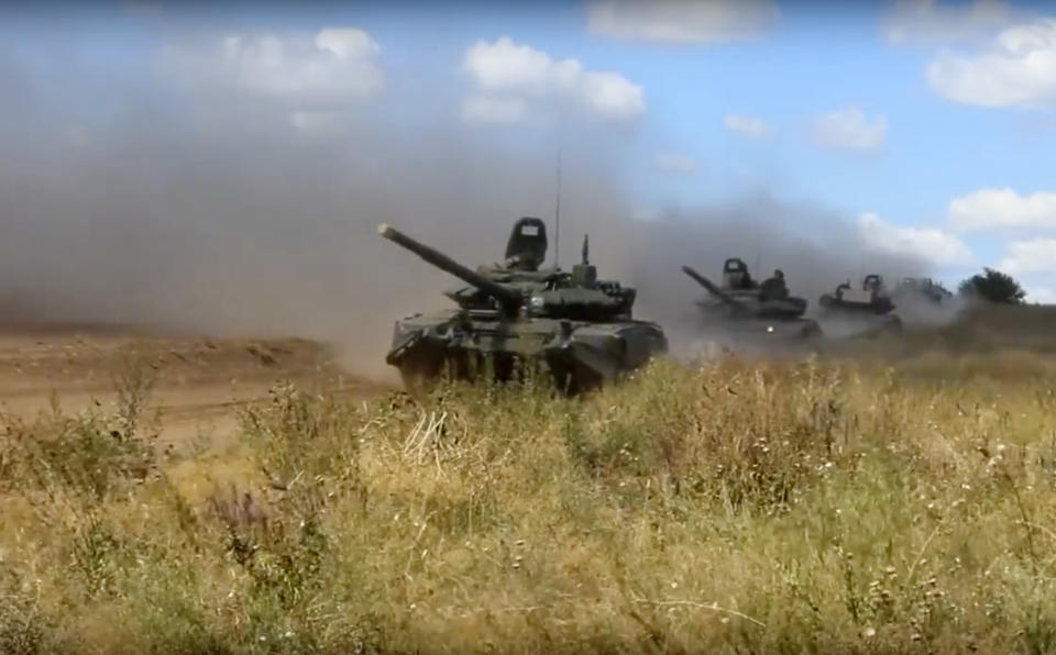 In this photo taken from video provided by Russian Defense Ministry Press Service on Tuesday, Sept. 11, 2018, tanks roll during the military exercises in the Chita region, Eastern Siberia, during the Vostok 2018 exercises in Russia. Russia's military chief of staff says that the military exercises expected to be the biggest in three decades, will involve nearly 300,000 troops. (Russian Defense Ministry Press Service pool photo via AP)