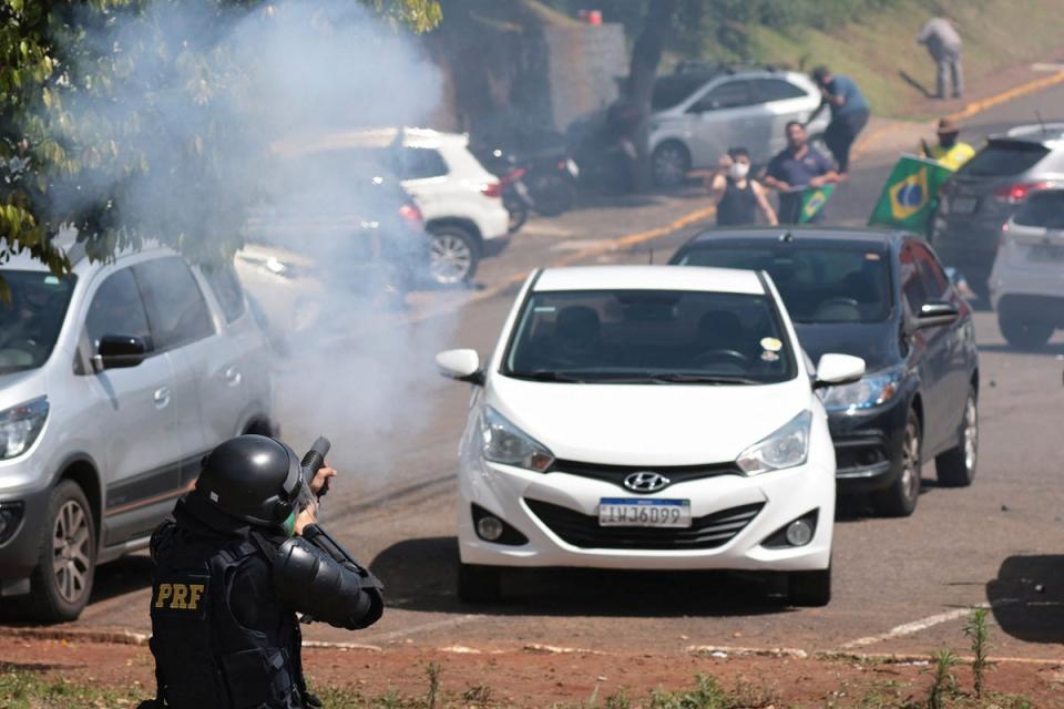 Military police fire at a roadblock by Bolsonaro supporters on the BR-116 highway in Rio Grande do Sul State, Brazil (AFP/Getty)