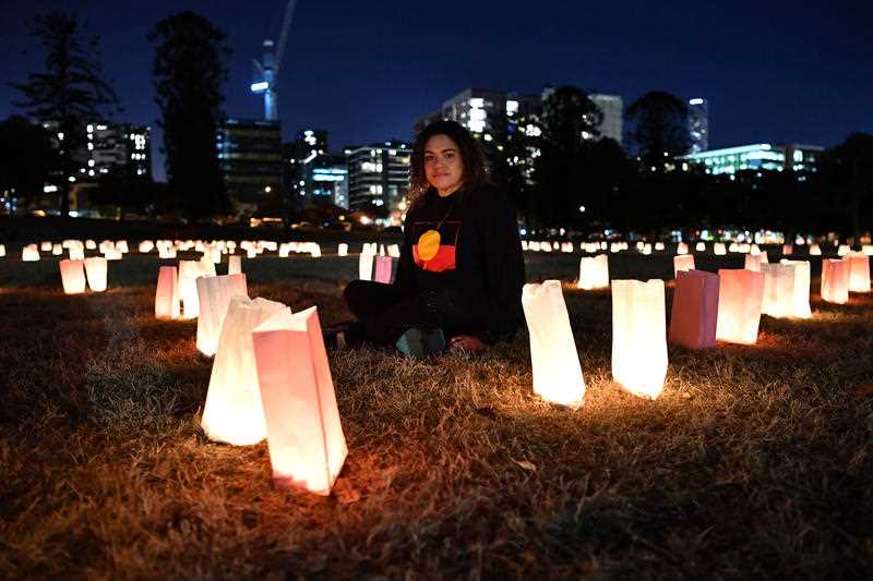A Widjabul woman from the Bundjalung Nations, Larissa Baldwin, is seen during the candlelight vigil to protest against the deaths in custody of Aboriginal and Torres Strait Islander people held in Musgrave Park in Brisbane.