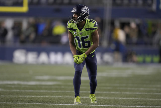 Wide receiver Tyler Lockett of the Seattle Seahawks smiles between