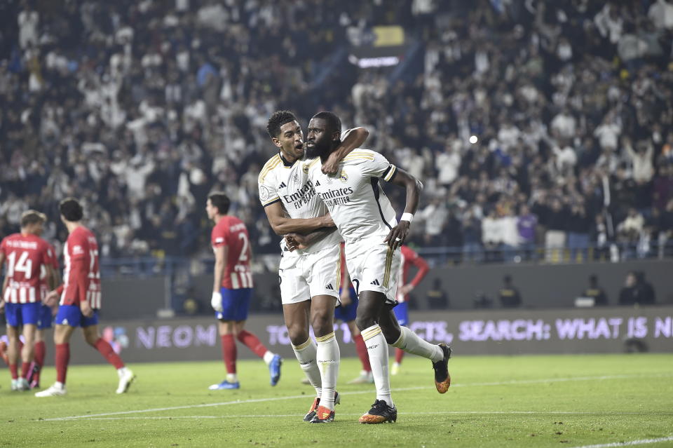 Real Madrid's Antonio Rudiger, right, celebrates scoring their first goal with Jude Bellingham during the Semi Final of Spanish Super Cup match between Real Madrid and Atletico Madrid at Al Awal Park Stadium in Riyadh, Saudi Arabia, Wednesday, Jan. 10, 2024. (AP Photo)