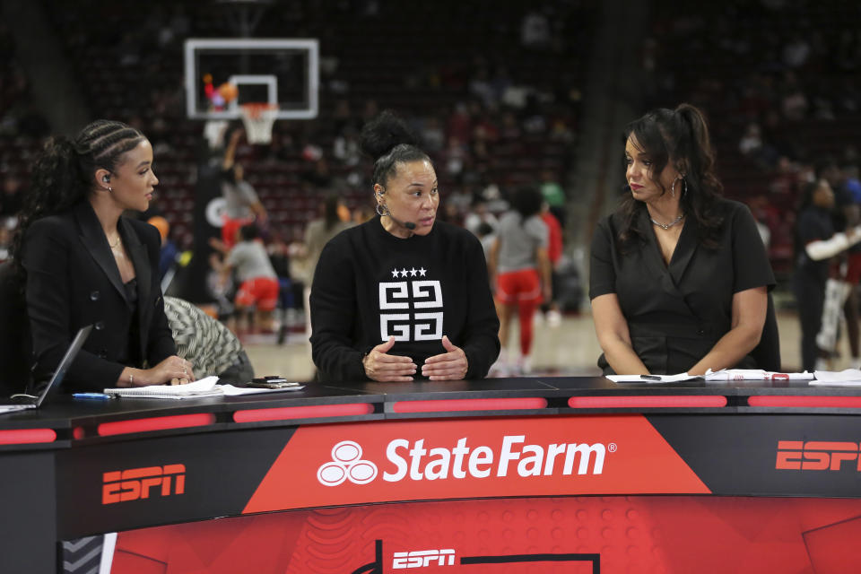 South Carolina head coach Dawn Staley, center, joins the set of ESPN College GameDay before an NCAA college basketball game against Georgia Sunday, Feb. 18, 2024, in Columbia, S.C. (AP Photo/Artie Walker Jr.)