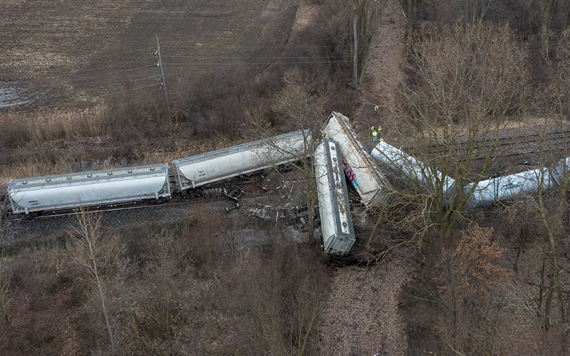 An emergency crew works at the site of a Norfolk Southern train derailment