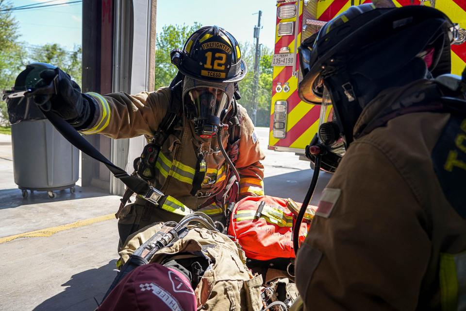 Zulema Dominguez, a firefighter for Travis County ESD No. 12, conducts a downed firefighter extraction training in Manor. Dominguez said the best part of the job is being a role model for girls, including her daughter.