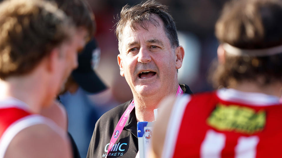 Ross Lyon speaks to St Kilda players during a pre-season game.