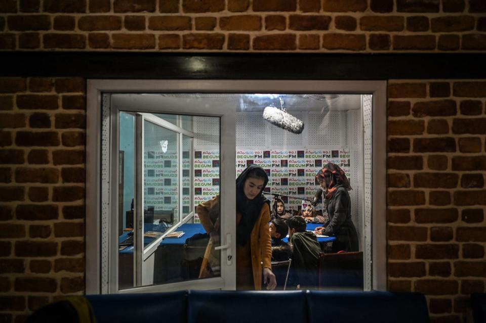 Women wearing headscarves are pictured inside a recording studio.