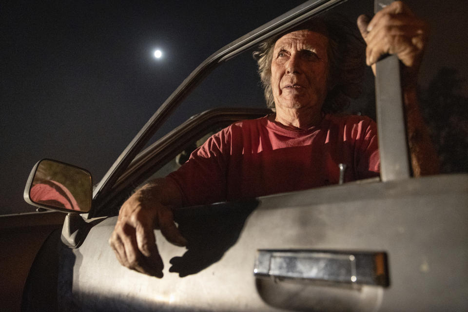 Tom Smith stares at a burning home on Platina Road after refusing to evacuate from the Zogg Fire near Ono, Calif., on Sunday, Sep. 27, 2020. (AP Photo/Ethan Swope)