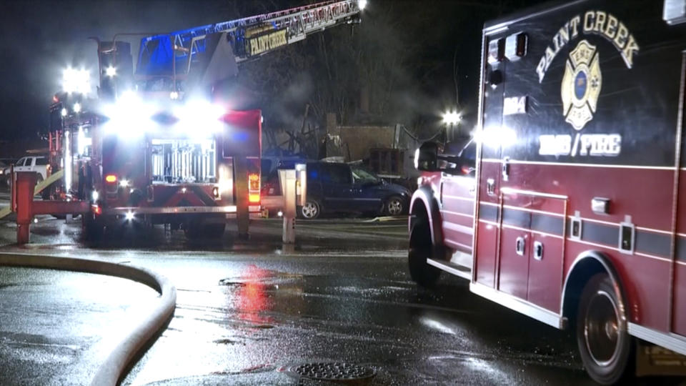 In this image taken from video provided by WCPO, emergency personnel work at the scene of a deadly fire at Jimbo’s Auto Repair, Tuesday, Nov. 28, 2023, in Hillsboro, Ohio. An explosion at the auto repair shop in Ohio that killed three people and sent a fourth person to a hospital sparked a massive fire that burned for hours and spewed thick, black smoke into the air (WCPO via AP)