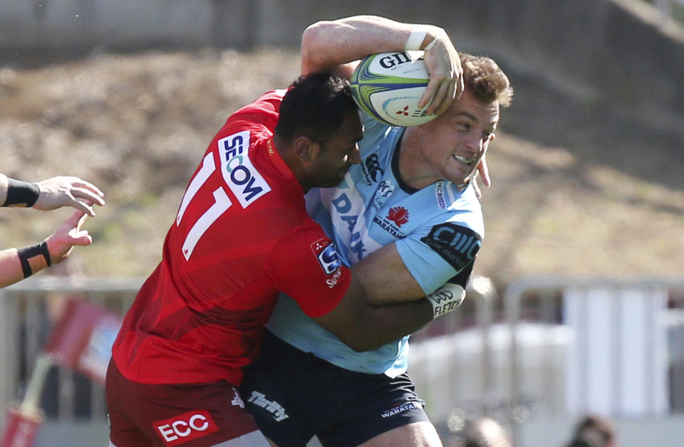 Waratahs' Jack Dempsey, right, is tackled by Semis Mastrewa of Sunwolves during their Super Rugby match in Tokyo, Saturday, Feb. 23, 2019. Waratahs won the match 31-30. (AP Photo/Koji Sasahara)