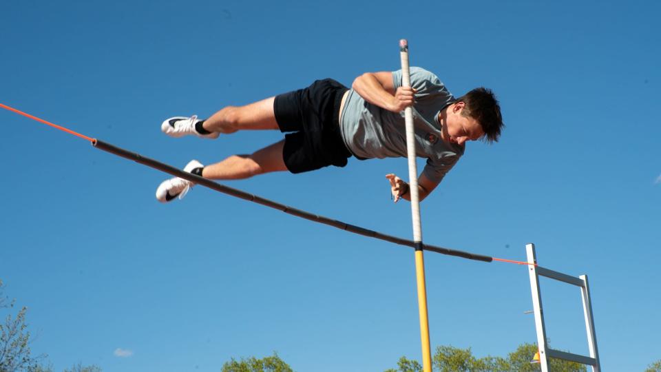 New Richmond sophomore Grant Harrison clears a bungee cord in a practice before the Southern Buckeye Academic and Athletic Conference league meet. Pole vaulters often practice with bungee cords to prevent injury and to focus on their technique rather than simply jumping a certain height.