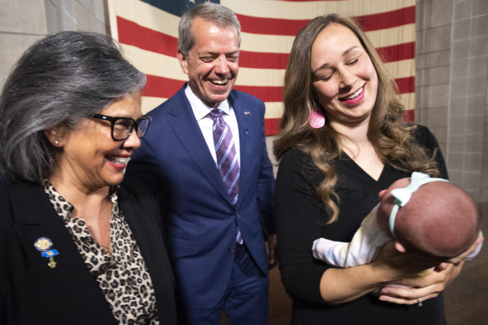 From left, Nebraska State Sen. Rita Sanders and Gov. Jim Pillen greet supporter Mikayla Pond and her newborn Gemma Pond, of Lincoln, Neb., after the signing of LB 574, Monday, May 22, 2023, in Lincoln, Neb. (Justin Wan/Lincoln Journal Star via AP)