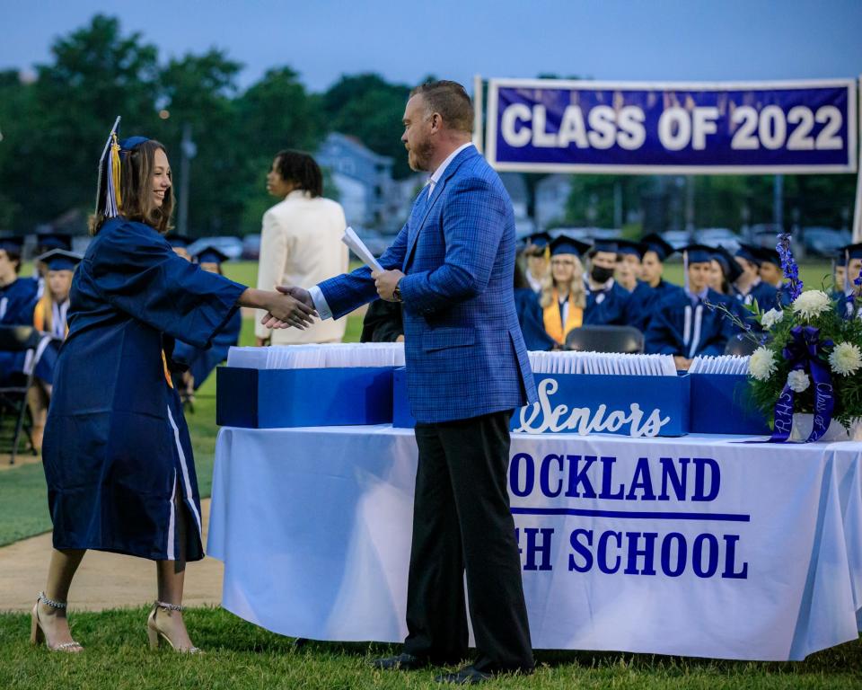 Maria Pala, Class of 2022 secretary, receives her diploma from Daniel Biggins, chairman of the Rockland School Committee, during commencement exercises at Veterans Memorial Stadium on Friday, June 3, 2022.