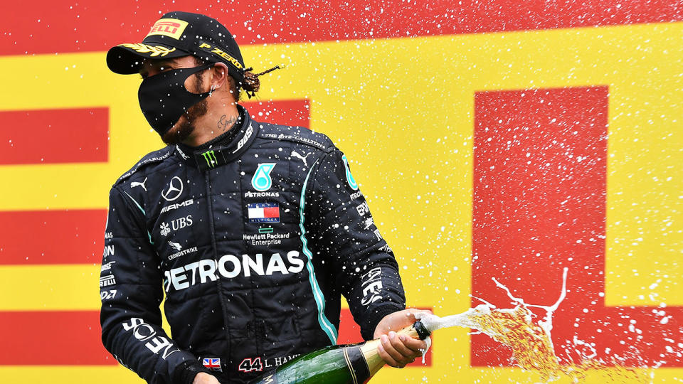 Lewis Hamilton pops the champagne after his Styrian GP win.