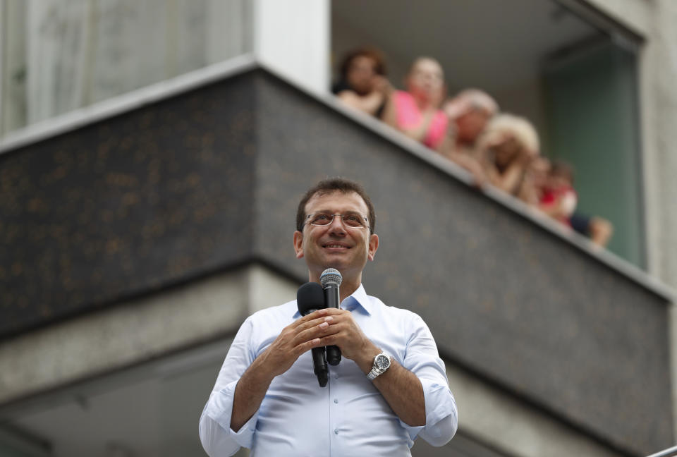 In this Wednesday, June 19, 2019 photo, Ekrem Imamoglu, mayoral candidate for Istanbul of the secular opposition Republican People's Party, or CHP, talks to supporters from atop his campaign bus during a rally in Istanbul, ahead of June 23 re-run of Istanbul elections. Millions of voters in Istanbul go back to the polls for a controversial mayoral election re-run Sunday, as President Recep Tayyip Erdogan's party tries to wrest back control of Turkey's largest city. (AP Photo/Lefteris Pitarakis)