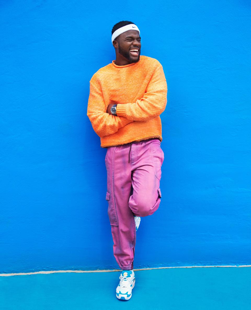 <cite class="credit">Sweater, $560, by Acne Studios / Pants, $1,450, by Ermenegildo Zegna Couture / Sneakers, $140, and headband, $6, by Nike / Watch, $2,500, by TAG Heuer</cite>