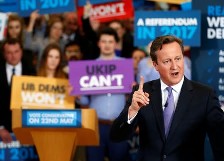 FILE PHOTO: Britain's Prime Minister David Cameron delivers a speech to placard waving Conservatives during an European election campaign rally at a science park in Bristol