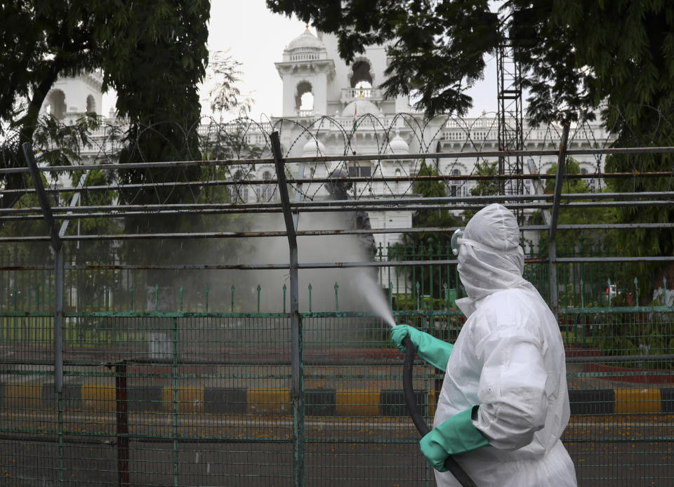 Members of disaster response force spray disinfectants as a precautionary measure against COVID-19 in Hyderabad, India, Monday, April 19, 2021. India now has reported more than 15 million coronavirus infections, a total second only to the United States. (AP Photo/Mahesh Kumar A.)