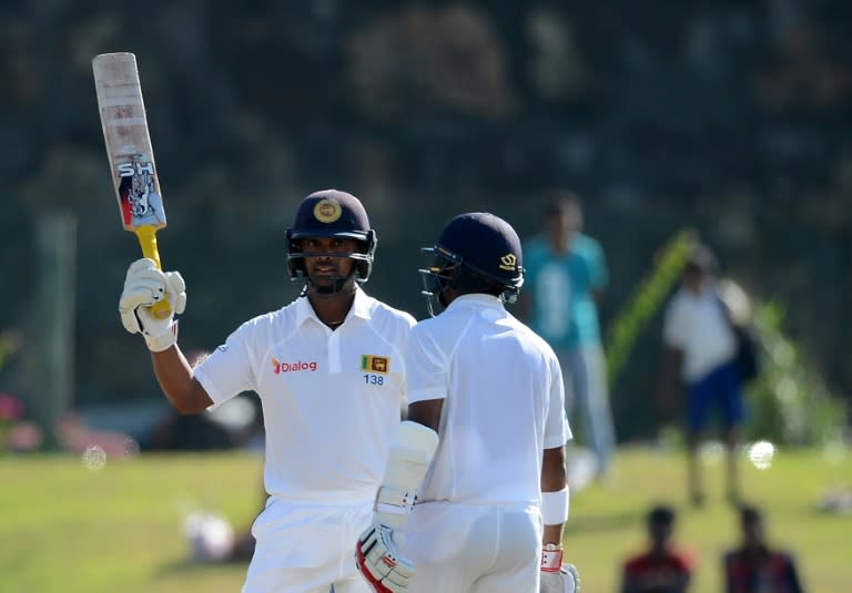 Sri Lanka's Asela Gunaratne (left) celebrates reaching his half-century on the first day of the opening Test against Bangladesh in Galle on March 7, 2017