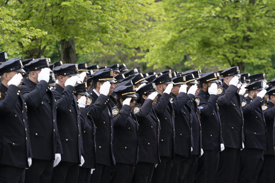 Police officers line the street as the funeral procession of New York police officer Anastasios Tsakos leaves the St. Paraskevi Greek Orthodox Shrine Church, Tuesday, May 4, 2021, in Greenlawn, N.Y. Tsakos was at the scene of an accident on the Long Island Expressway when he was struck and killed by an allegedly drunk driver a week ago. (AP Photo/Mark Lennihan)