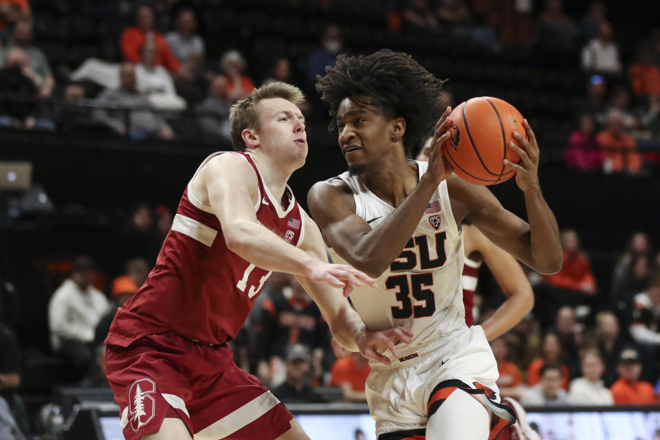 Oregon State forward Glenn Taylor Jr. (35) drives past Stanford guard Michael Jones (13) during the first half of an NCAA college basketball game in Corvallis, Ore., Thursday, March 2, 2023. (AP Photo/Amanda Loman)