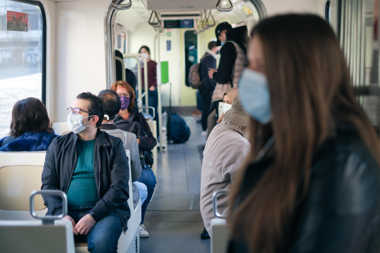 27 April 2020, Lower Saxony, Hanover: Passengers wear a mouthguard on the light rail system. Since Monday, masks have been mandatory in Lower Saxony for public transport and shops. Photo: Ole Spata/dpa (Photo by Ole Spata/picture alliance via Getty Images)